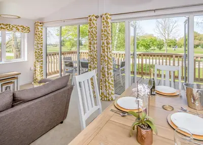 a living room with a couch and a table at Hawthorn Glen Lodges in Downham Market