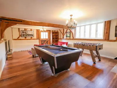 a living room with a pool table and a ping pong ball at Moat Barn in Debach