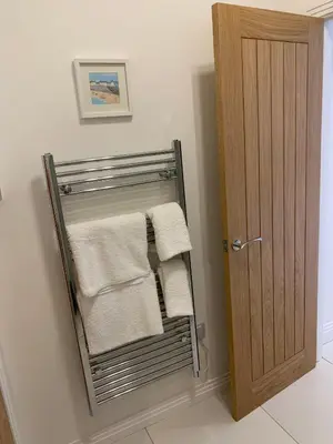 a towel rack with towels on it next to a door at The old forge in Graveley