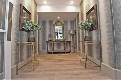 a hallway with two vases with flowers in it at Blanco Uno in Colchester