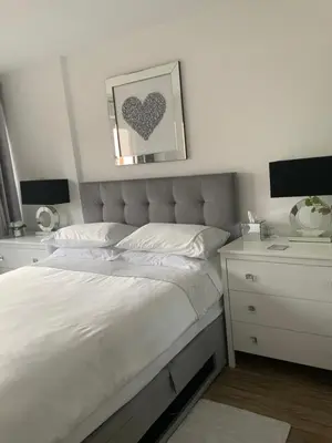 a bedroom with a white bed and a white dresser at Blanco Uno in Colchester
