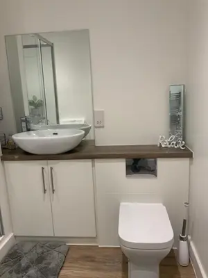 a bathroom with a white sink and a toilet at Blanco Uno in Colchester
