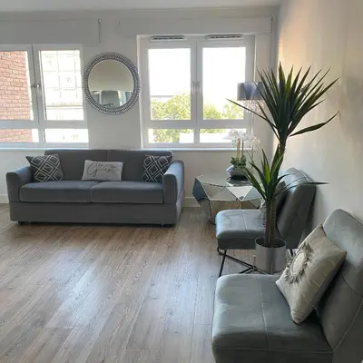 a living room with a couch and a table at Blanco Uno in Colchester