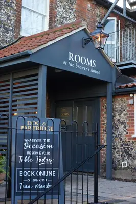 a restaurant with a sign in front of a building at Dog and Partridge by Greene King Inns in Bury Saint Edmunds
