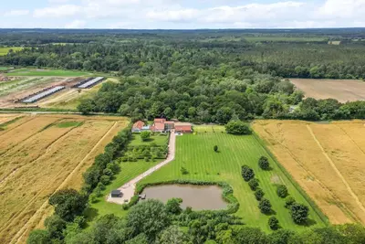 an aerial view of a farm with a pond at Cottage In Norfolk Sleeps 23 - Private Pool, Fishing Lake, Hot Tub Ref 99008Sc in Hockham