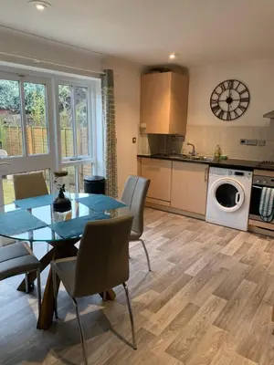 a kitchen and dining room with a table and chairs at 10 St Edmundsbury Mews in Bury Saint Edmunds