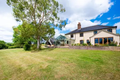 a large white house with a large yard at 4 Bed in Spexhall oc-fairs in Spexhall