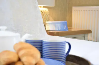 a table with blue and white plates and a bowl of bread at The Red Brick House, Aldeburgh in Aldeburgh
