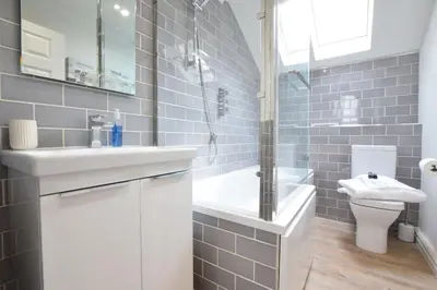 a bathroom with a sink and a shower and a toilet at The Red Brick House, Aldeburgh in Aldeburgh