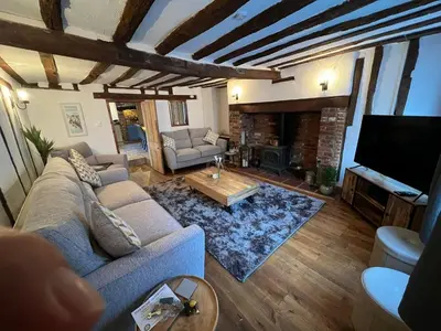 a living room with a couch and a tv at 4 Bedroom townhouse on one of the oldest streets in Wymondham