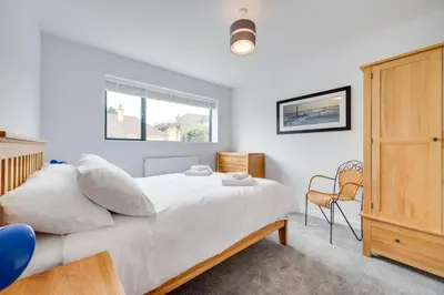 a bedroom with a large white bed and a window at 5 Bed in Aldeburgh oc-pops in Aldeburgh