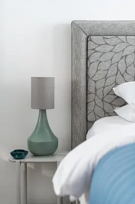 a bedroom with a bed with a green lamp on a table at City Center,2 Bedroom Apartment with Parking in Cambridge