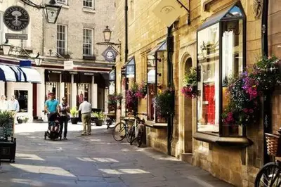 a city street with people walking down a street at City Center,2 Bedroom Apartment with Parking in Cambridge