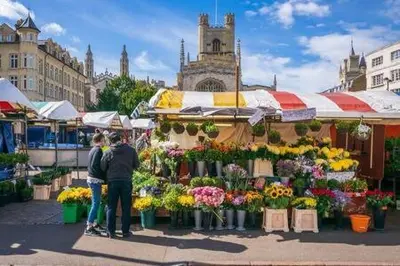 a group of people standing in front of a flower market at City Center,2 Bedroom Apartment with Parking in Cambridge