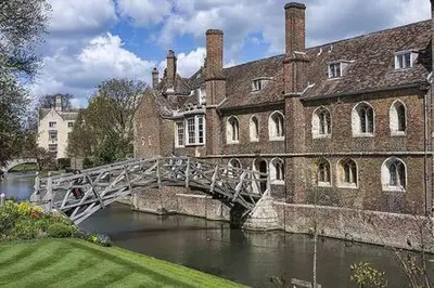 a bridge over a river in front of a building at City Center,2 Bedroom Apartment with Parking in Cambridge