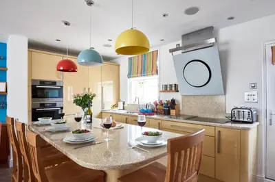 a kitchen with a table with glasses of wine at 252 Aldeburgh Townhouse - Aldeburgh Coastal Cottages in Aldeburgh