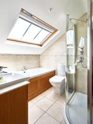 a bathroom with a sink toilet and a skylight at 252 Aldeburgh Townhouse - Aldeburgh Coastal Cottages in Aldeburgh