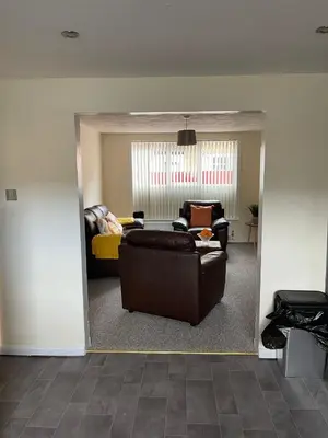 a living room with a couch and a chair at Sea Breeze in Harwich