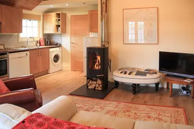 a living room with a fireplace in the middle of it at 1 Bed in Debenham oc-glah in Worlingworth