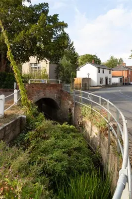 an old bridge on the side of a road at Vine Cottage in Walsham le Willows