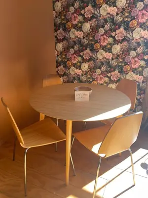 a wooden table with two chairs and a table with a sign on it at Top House -Stylish property in village location in Bildeston