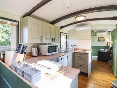 a kitchen with white cabinets and a counter top at The Brake Wagon at High Barn Heritage in Halstead