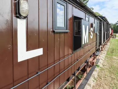 a train with the letter l on the side of it at The Brake Wagon at High Barn Heritage in Halstead