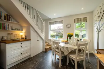 a kitchen and dining room with a table and chairs at Pinewood - Aldeburgh Coastal Cottages in Aldeburgh
