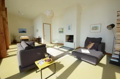 a living room with two couches and a fireplace at Upper Lodge, Shotley in Chelmondiston