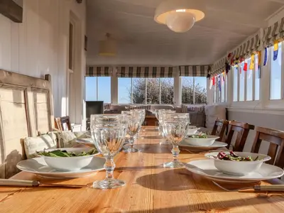 a table with wine glasses and bowls on it at Valetta, Thorpeness in Thorpeness