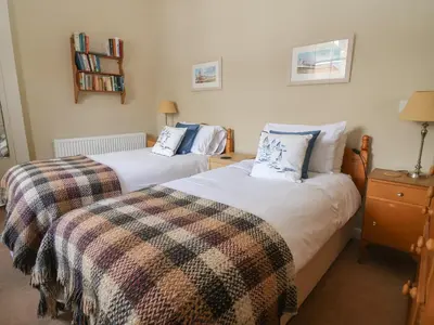 two twin beds in a room with at Crabbe House in Aldeburgh