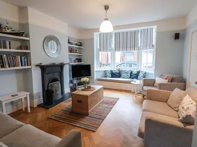 a living room with two couches and a fireplace at Lavender House, Aldeburgh in Aldeburgh