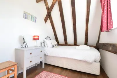 a bedroom with a bed and a dresser at 1 Grange Cottages, Westleton in Westleton