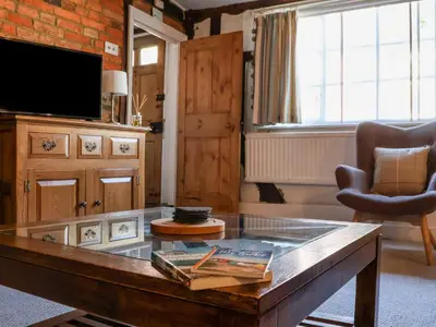 a living room with a coffee table and a tv at Lavender Cottage, Aldeburgh in Aldeburgh
