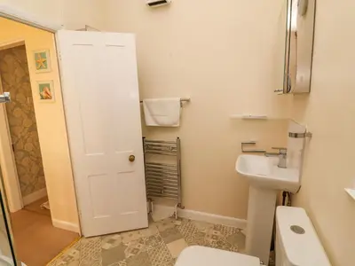 a bathroom with a white toilet and a sink at Winkle Cottage, Aldeburgh in Aldeburgh