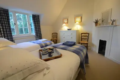 a bedroom with two beds with a tray on it at 2 The Bays, Thorpeness in Thorpeness