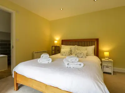 a bedroom with a bed with two towels on it at Quill Farm Barn in Campsea Ashe