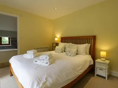 a bedroom with a bed with towels on it at Quill Farm Barn in Campsea Ashe