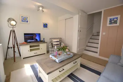 a living room with a couch and a table and a television at Alinka, Aldeburgh in Aldeburgh