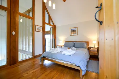 a bedroom with a bed with two towels on it at Two Chantry Barns, Orford in Orford