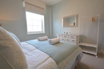 a bedroom with a bed with two pillows on it at Skimming Stones, Aldeburgh in Aldeburgh