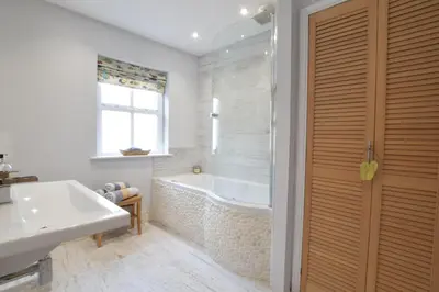 a bathroom with a tub and a sink at 53 Tern Cottage, Aldeburgh in Aldeburgh