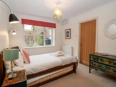 a bedroom with a bed and a window at Mellows, Thorpeness in Thorpeness