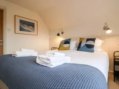 a bedroom with a bed with towels on it at Mellows, Thorpeness in Thorpeness