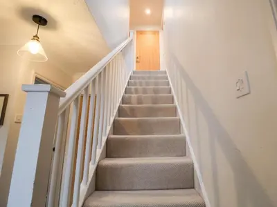 a staircase in a home with a stair case at Mellows, Thorpeness in Thorpeness