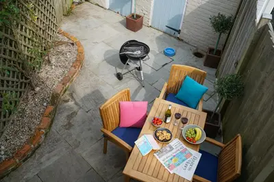 an overhead view of a table and chairs on a patio at Smugglers Rest, Aldeburgh in Aldeburgh