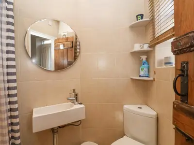 a bathroom with a sink and a toilet and a mirror at Rosemary Cottage, Aldeburgh in Aldeburgh