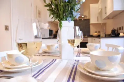 a table with two glasses of white wine on it at High Tide, Crabbe Street, Aldeburgh in Aldeburgh