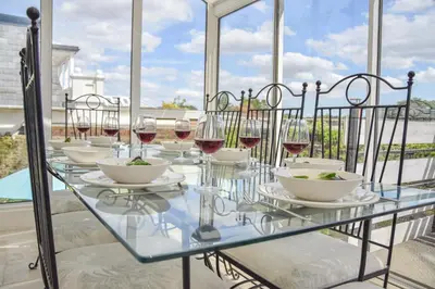 a glass table with wine glasses and bowls on it at Beresford House in Woodbridge