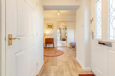 a hallway with a white door and a table at 3 Bed in Theberton oc-1pcs in Theberton